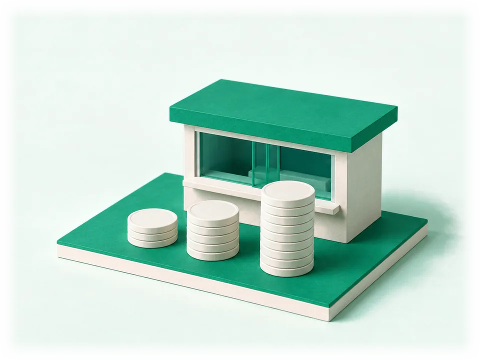 Model of three stacks of large coins of different heights in front of a small currency exchange booth with a glass window